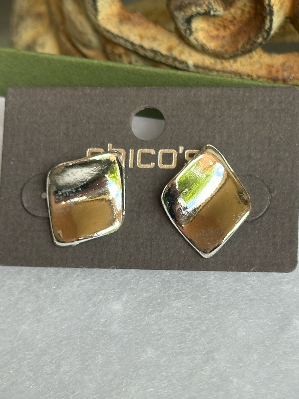 Chico's silver-tone earrings feature a polished, slightly curved geometric shape